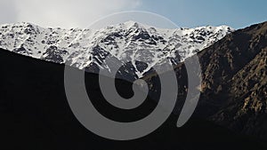 Snowy mountains meeting the cloudy sky