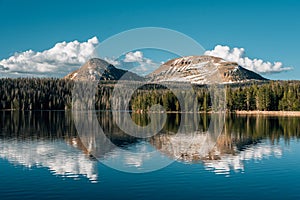 Snowy mountains reflecting in Trial Lake, in the Uinta Mountains, Utah photo