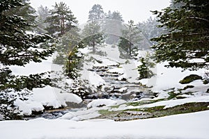 Snowy mountains with river in Madrid.