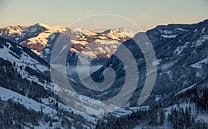 Snowy mountains sunset landscape mountainscape valley view glimmering light blue hour