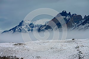 Snowy mountains in Torres del Paine National Park, Chile on a foggy day