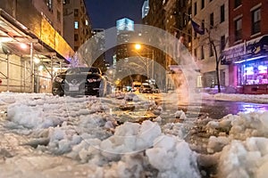 A snowy night time street in Brooklyn New York