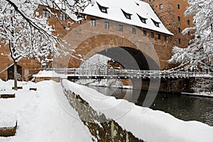 Snowy Nuremberg, Germany- iron bridge ( Kettensteg), old town city walls