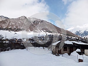 Snowy Old towers (Svan towers) and houses in the mountains, in winter. Mestia, Georgia