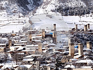 Snowy Old towers (Svan towers) and houses in the mountains, in winter. Mestia, Georgia