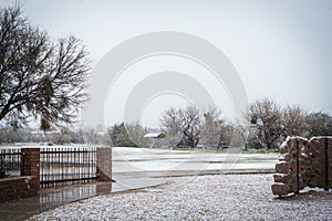 Snowy park with fence and playground in Tucson Arizona