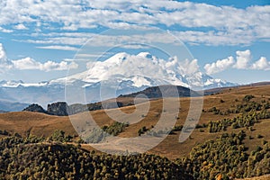 Snowy peak of Mount Elbrus in spring. Road to Dzhyly Su. Caucasus mountains. Jilly-Su region. Kabardino-Balkaria Reublic. Panorama