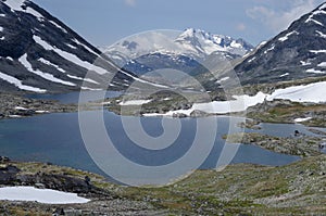 Snowy peaks and lakes landscape of Jotunheimen mountains, Norway