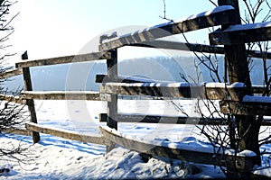 Snowy ranch fence and snow filled corral winter time