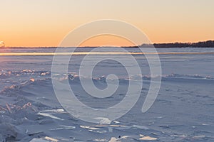 On the snowy riverbank landscape. Winter snow scene. Winter river in snow