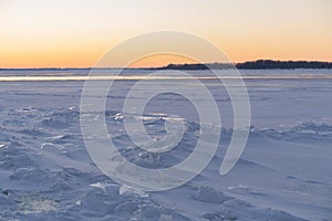 On the snowy riverbank landscape. Winter snow scene. Winter river in snow