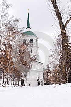 A snowy road leads to a church or cathedral.