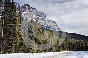 Snowy Road in a Mountain Landscape on a Cloudy Winter Day