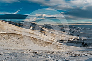 Snowy road and mountains in winter