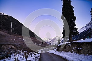 Snowy road passing through Mountain range