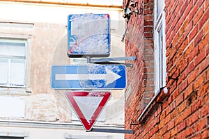 Snowy road signs in the city - End of living street, One-way-street, Give way