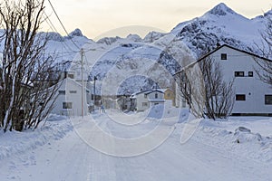 Snowy road through the township of Mefjordvaer