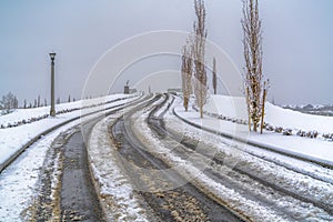 Snowy road with tracks during winter in Daybreak