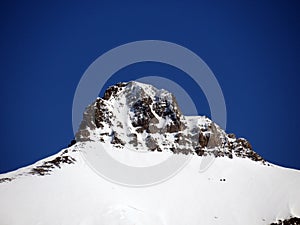 Snowy and rocky alpine mountain peak Oldenhorn in the Les Diablerets massif seen from the Les Diablerets settlement - Suisse