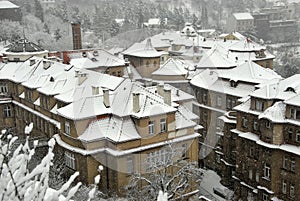 Snowy roofs of old houses in Prague PodolÃ­