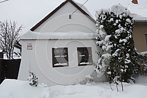 Snowy rural house in village during the cold winter