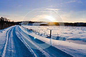 Snowy rural road at sunrise