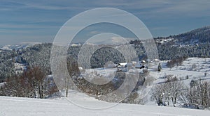 Snowy scenery with wooden house settlement