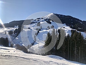 Snowy slopes in the mountains with blue sky