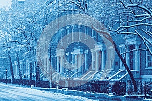 Snowy street scene of historic buildings along Washington Square in New York City