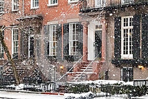 Snowy street scene with the historic buildings along Washington Square Park during a winter noreaster storm in New York City photo