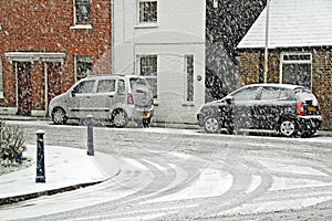 Snowy street scene parked cars