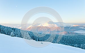 Snowy sunrise mountain landscape