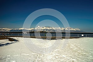 Snowy surrounding around reservoir Cierny Vah in Slovakia. View on the legendary peak in Slovakia -. Krivan. Unique