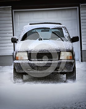 Snowy SUV parked in a driveway