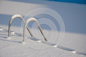 Snowy swimming pool stairs