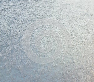 Snowy texture on the hood of a car