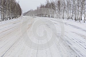 Snowy track in cloudy weather with a blizzard