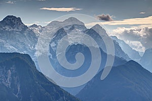 Snowy Triglav peak and misty Kot Valley, Julian Alps, Slovenia