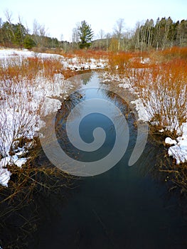 Snowy view of winter stream in FingerLakes nature preserve