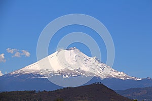 Snowy volcano Popocatepetl with blue sky in puebla, mexico VI