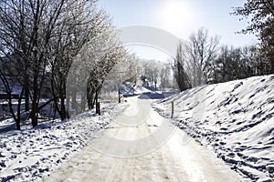 A snowy way. A road in the trees.Winter backgroung. Amazing winter. A snowy trees, a car tracks, footsteps in snow