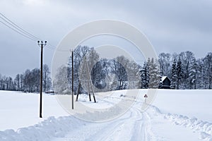 Snowy white road where along the edge runs