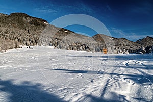 Snowy winter country with hill at background