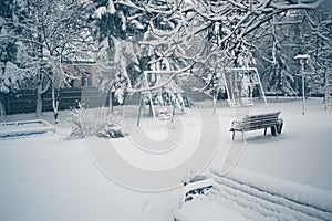 Snowy winter day on a playground in the snow. photo