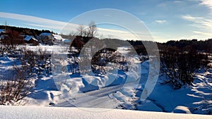 Snowy winter forest countryside . Wooden log houses Russian village covered snow. Winter Russia