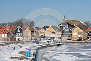 Snowy winter landscape Dutch fishing village Urk with frozen harbor