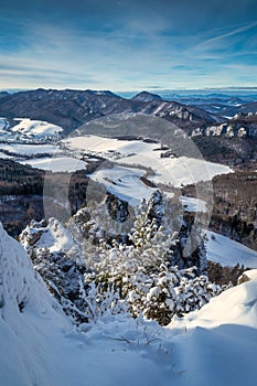 Snowy winter landscape with rocky mountain range