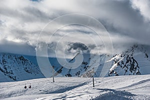 Snowy winter mountains in sun day. Georgia, from ski resort Gudauri.