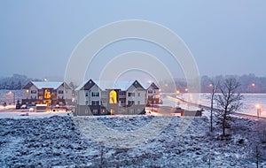 Snowy Winter night showing exterior of residential building