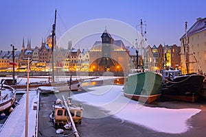 Snowy winter in the old town of Gdansk with frozen Motlawa river, Poland